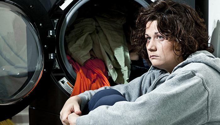 Picture Of Woman Crying In Front Of Her Front Load Washer