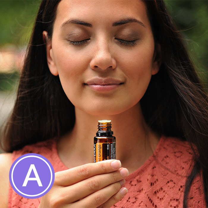 Woman inhaling orange essential oil